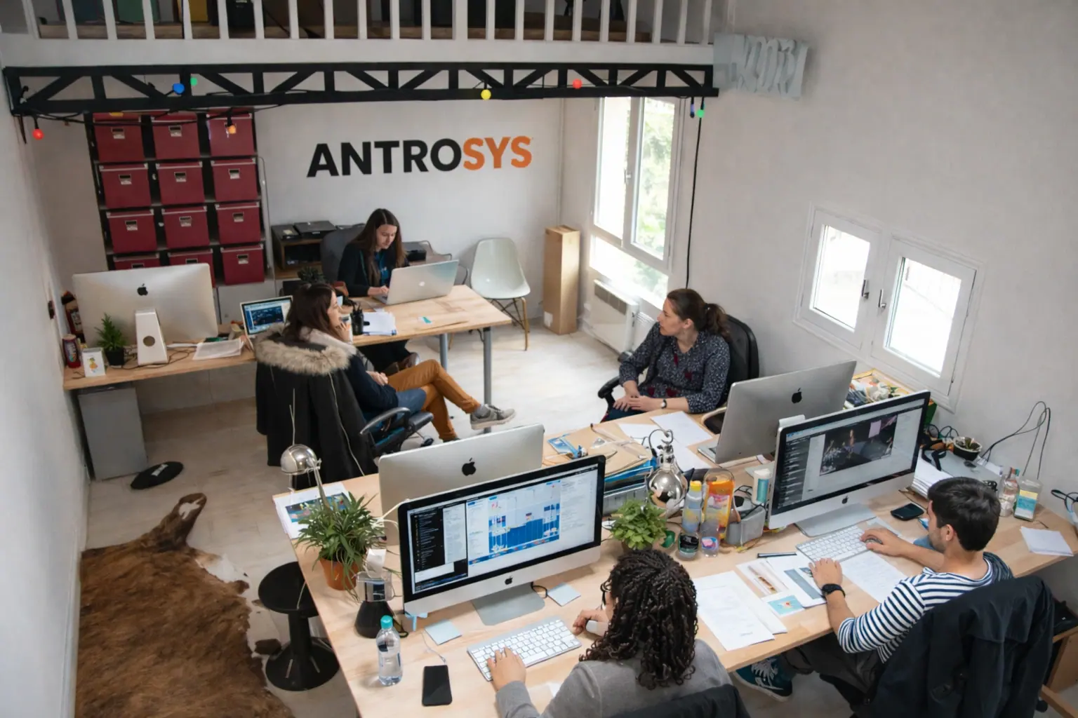 The AntroSys team working at shared desks in an open office